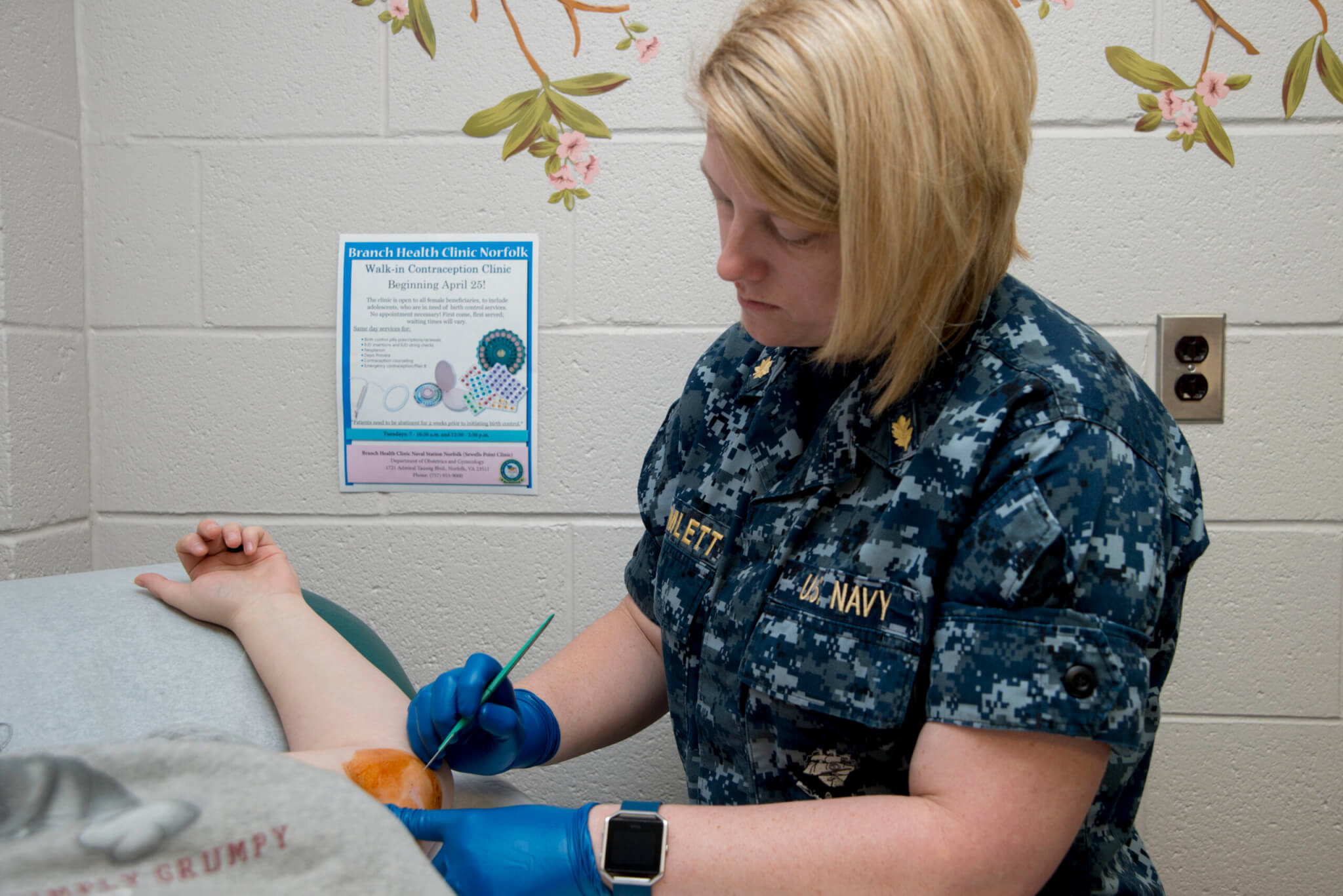 Lt. Cmdr. Stacey Hamlett removes Nexplanon from a patient’s arm during the opening day of the Walk-In Contraception Clinic at Branch Health Clinic Naval Station Norfolk, in 2017. Photo by Mass Communication Specialist 2nd Class (SW) Terah L. Bryant.
