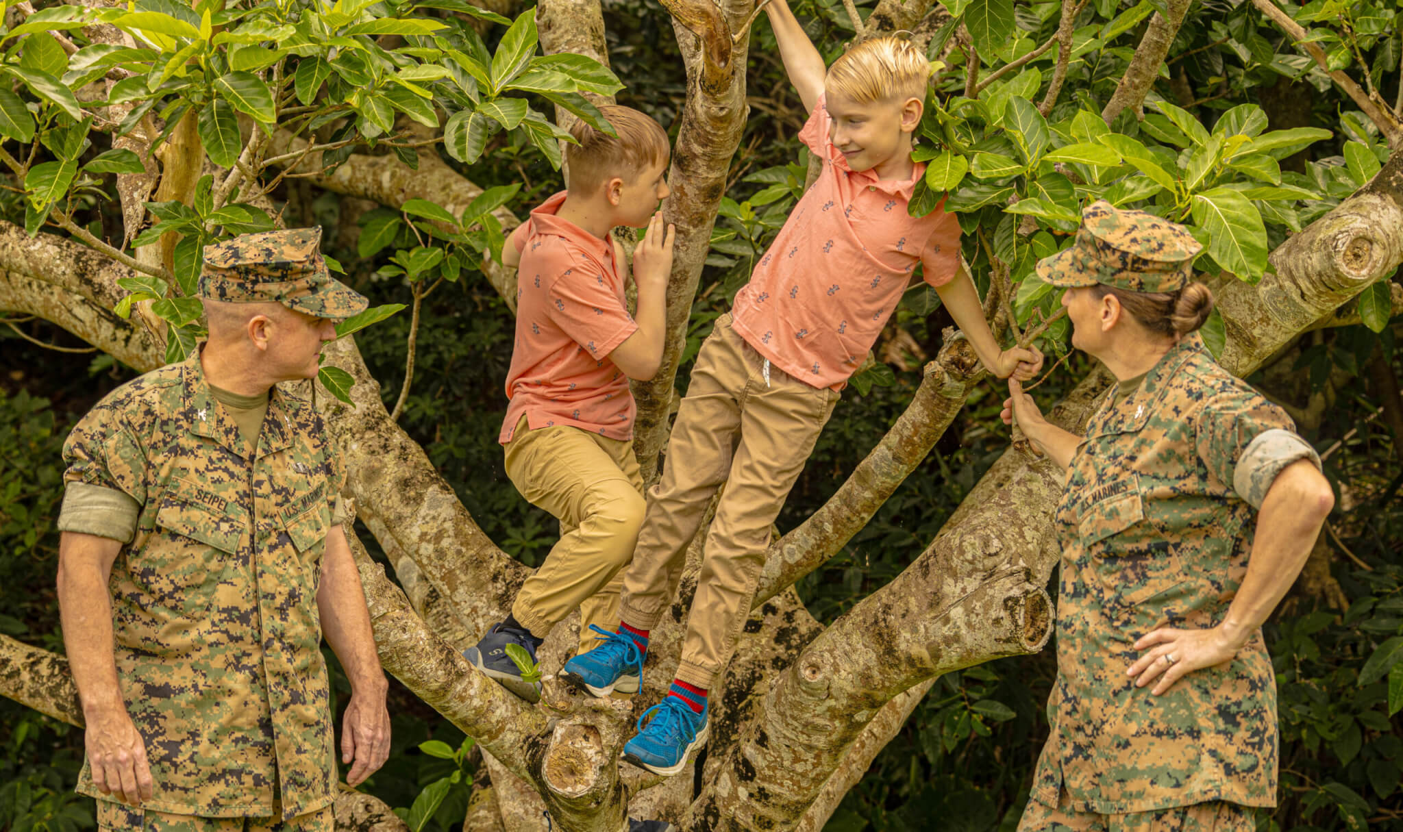 Col. Patrick Seipel and Col. Petra Seipel, both senior officers in charge of supply and logistics at the 3rd MEB and the 1st MAW, watch their sons, Harley and Max, climb a tree on Camp Courtney. Photo by 1st Lt. Samuel H. Barge