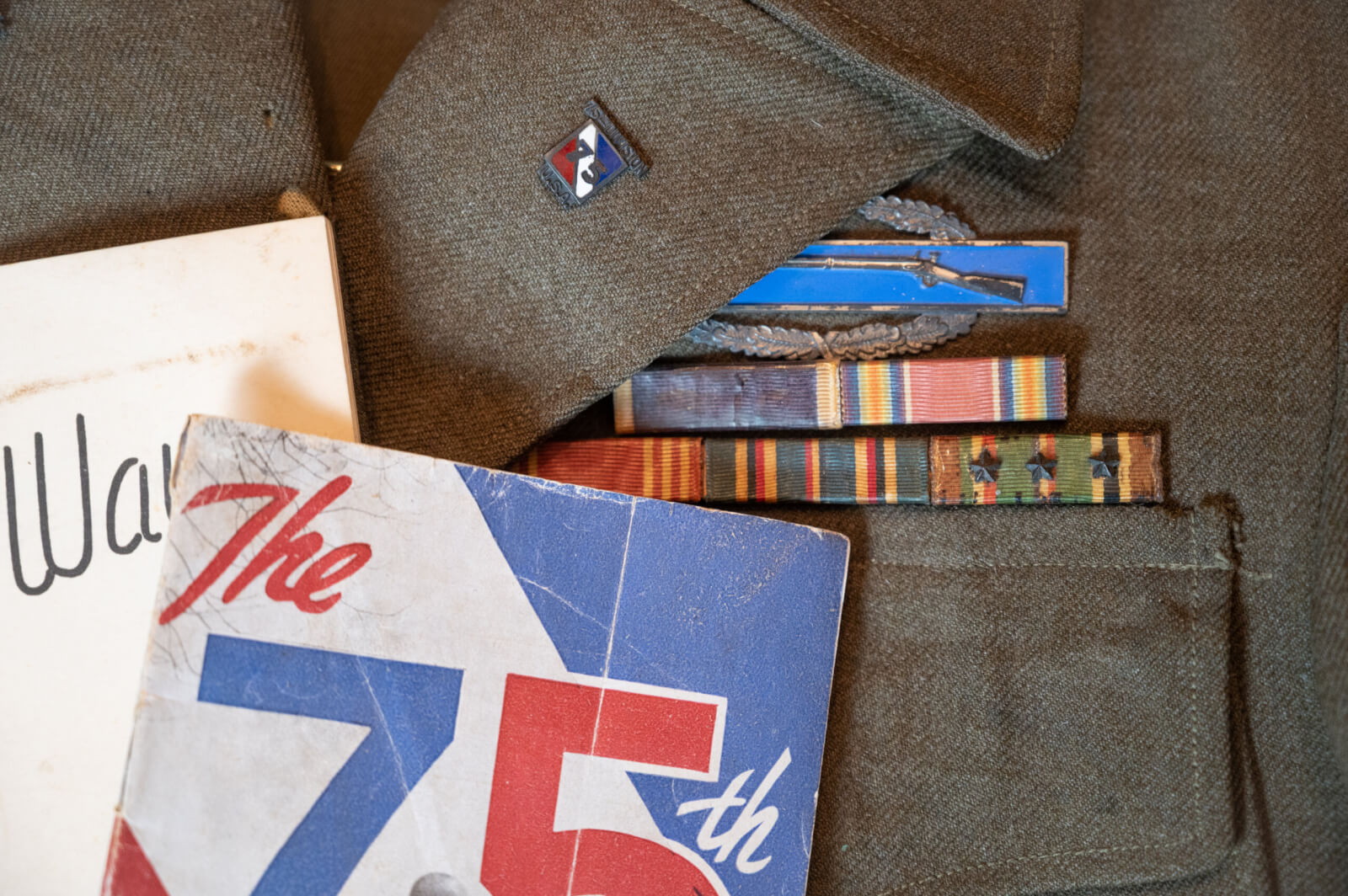 World War II veteran Vernon Brantley's military ribbons and Combat Infantryman Badge on his old uniform.