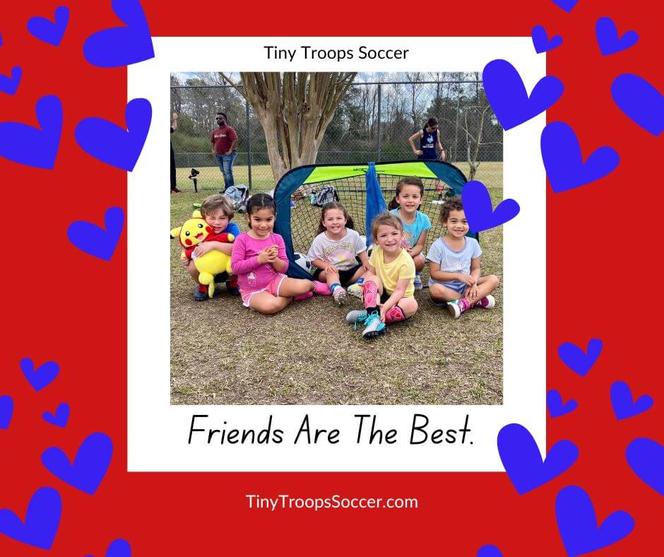 Children smile while sitting on the ground with Tiny Troops Soccer, a military-owned small business.