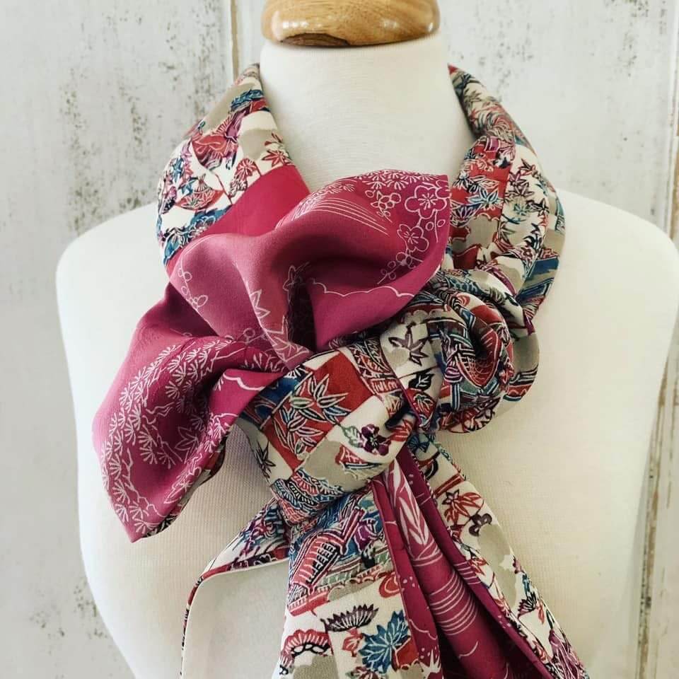 A pink scarf —made by Navy spouse business Mottainai Creations out of recycled kimono— tied delicately on a fabric mannequin.