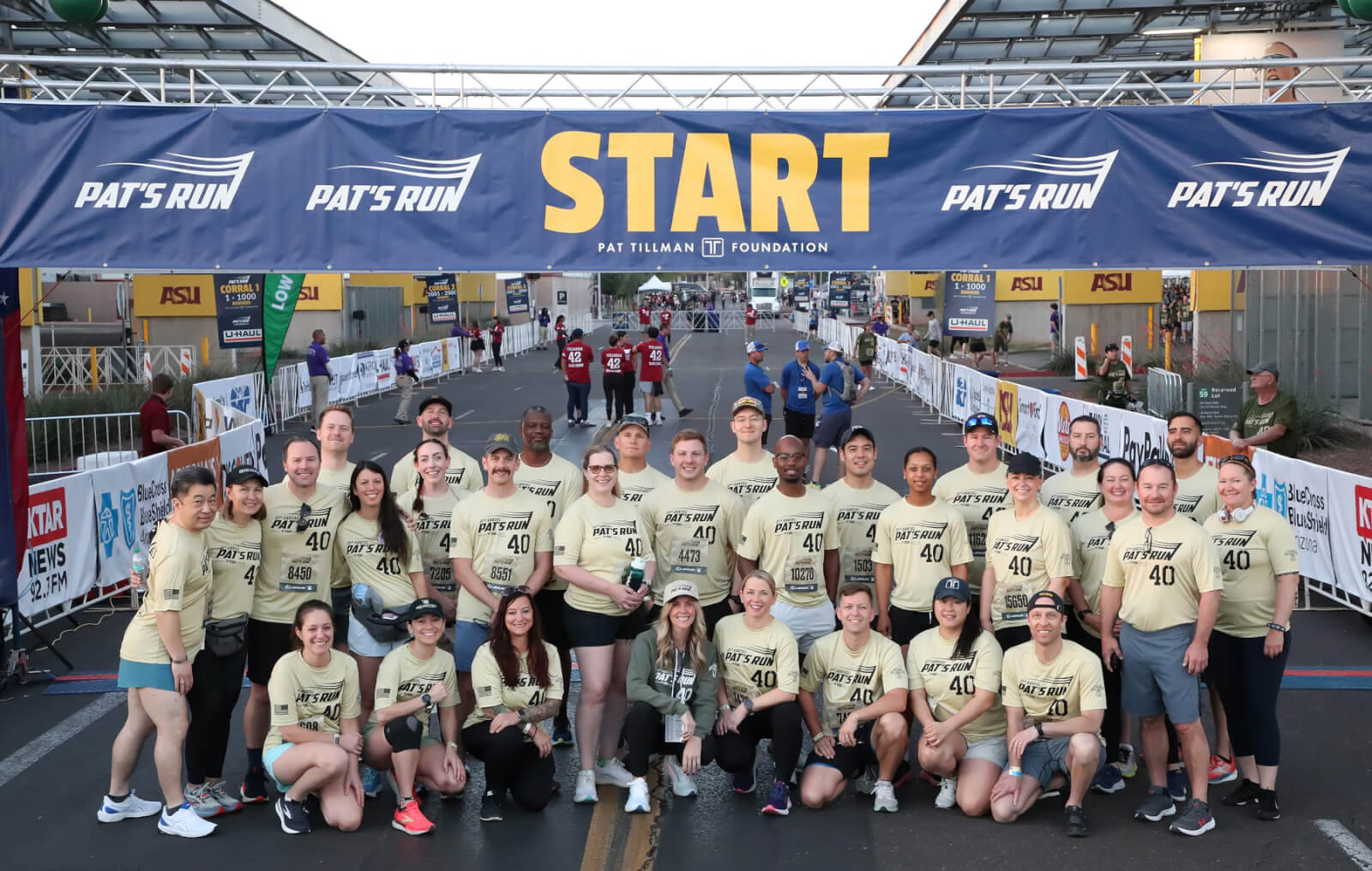 A group of Tillman Foundation Scholars gather in matching gold shirts at the starting line for the 2025 Pat's Run.