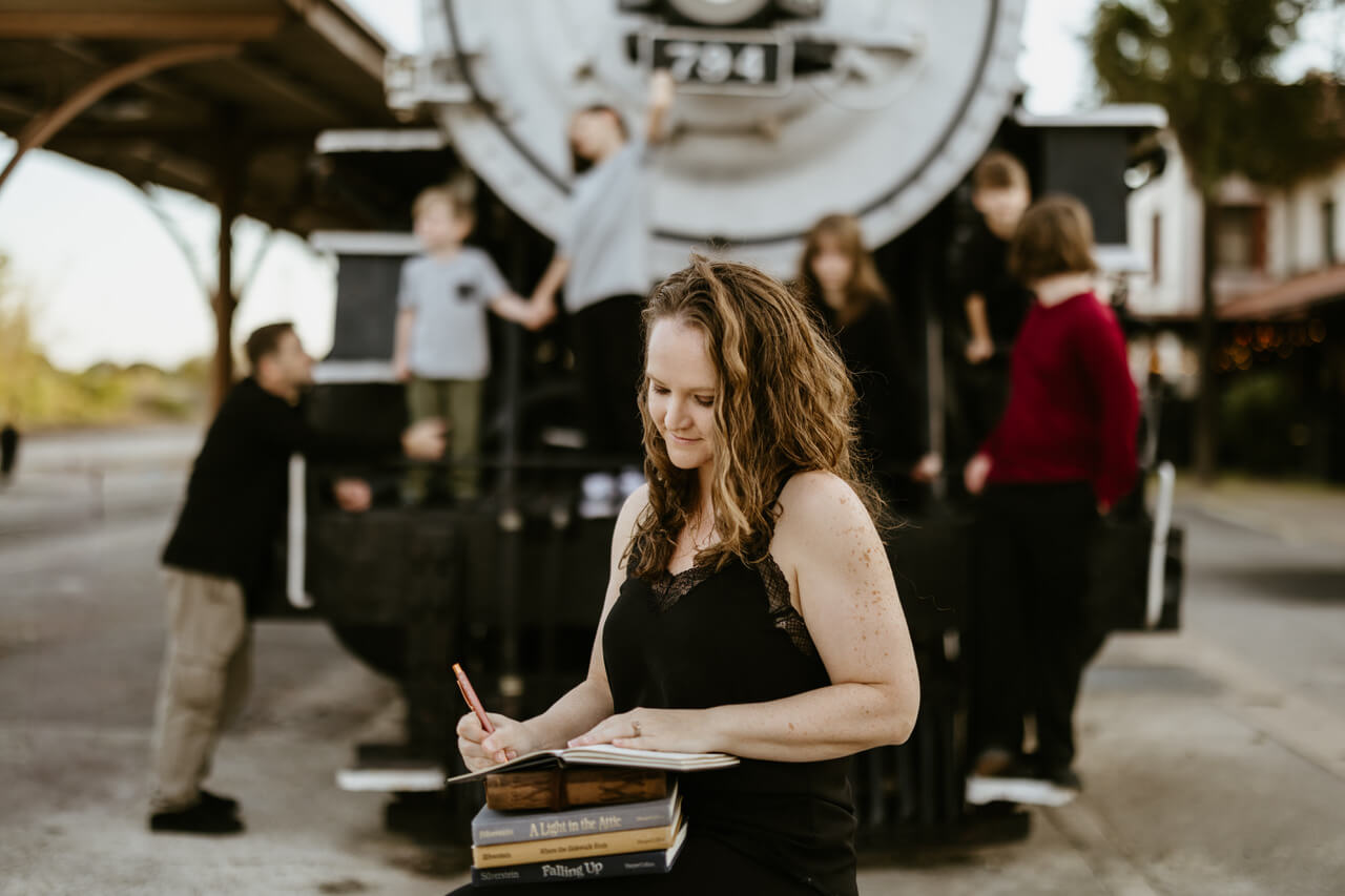 Veteran Jessi Cook taps into her creative side, writing in a journal as her family plays in the background.