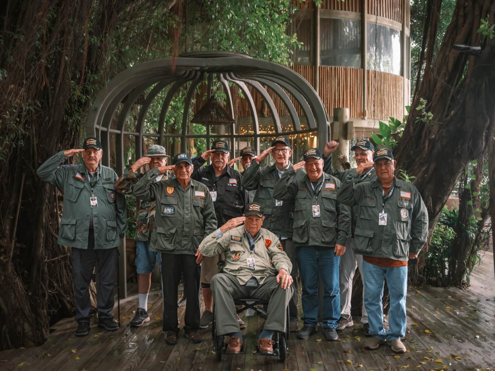 Vietnam War veterans in salute while staring at the camera.