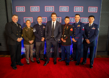 2026 USO Gala with Global Ambassador David Boreanaz and service members in uniform with the USO step and repeat in the background.