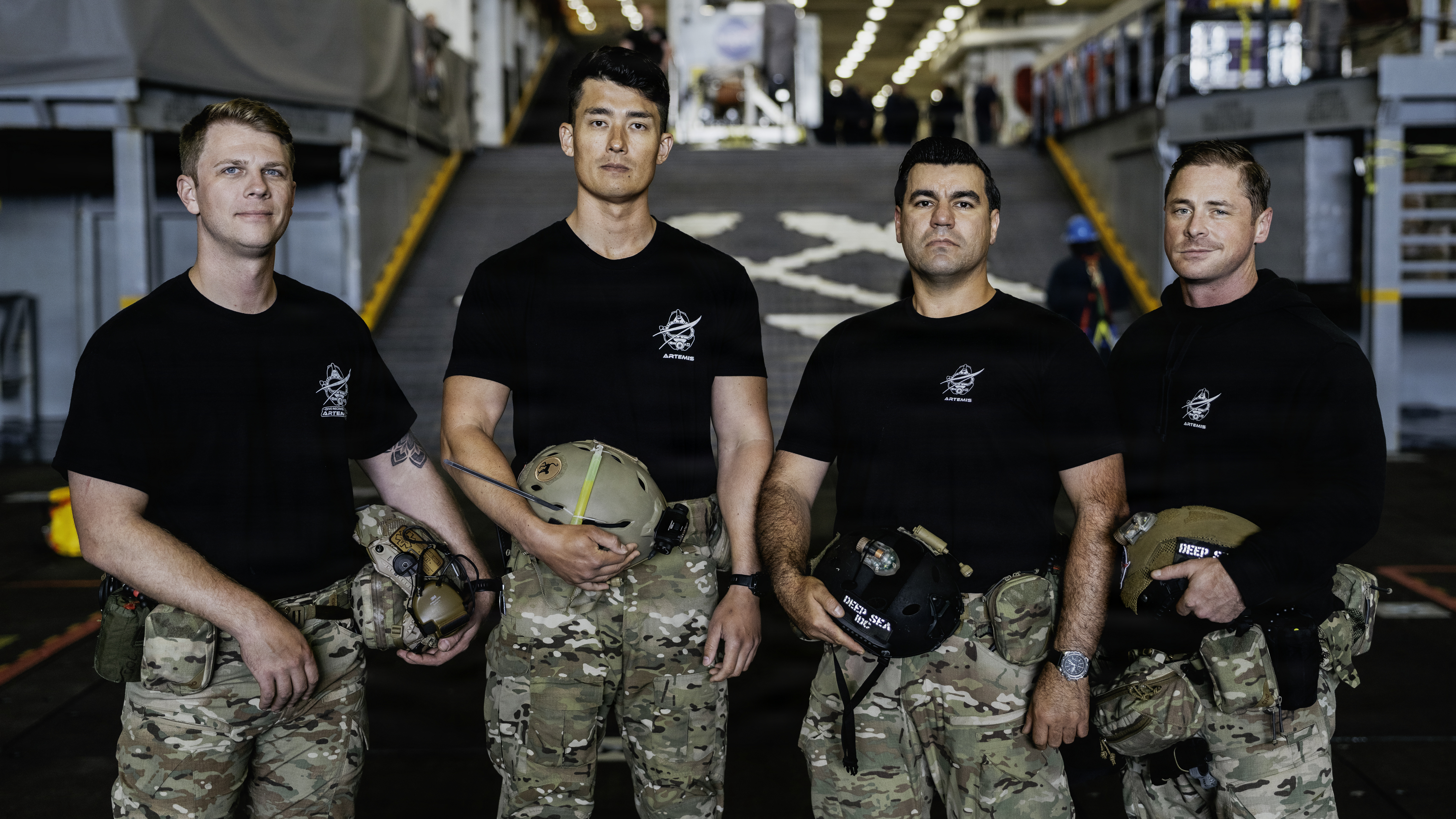 The U.S. Navy dive medical team with Explosive Ordnance Disposal Group 1, pose for a group photo ahead of Artemis II recovery operations while underway on Amphibious transport dock ship USS John P. Murtha. 